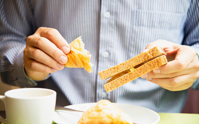 man having meal with bread